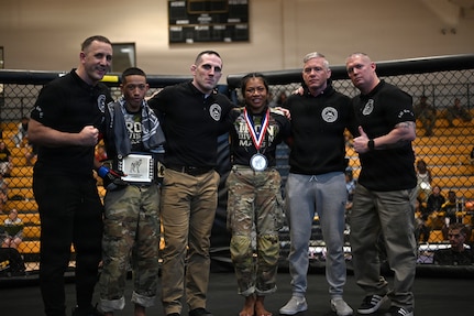 U.S. Army Spc. Isaiah Castellanos (2nd from left), District of Columbia National Guard, and Spc. Sandra Chheng, Pennsylvania Army National Guard, compete in the bantamweight finals during day three of the 2026 Lacerda Cup All-Army Combatives Championship at Fort Benning, Ga. Apr. 10, 2026. The two Army National Guard teams finished the tournament with third and sixth place team standings out of twenty-one teams competing, with three National Guard Soldiers earning championship belts.
