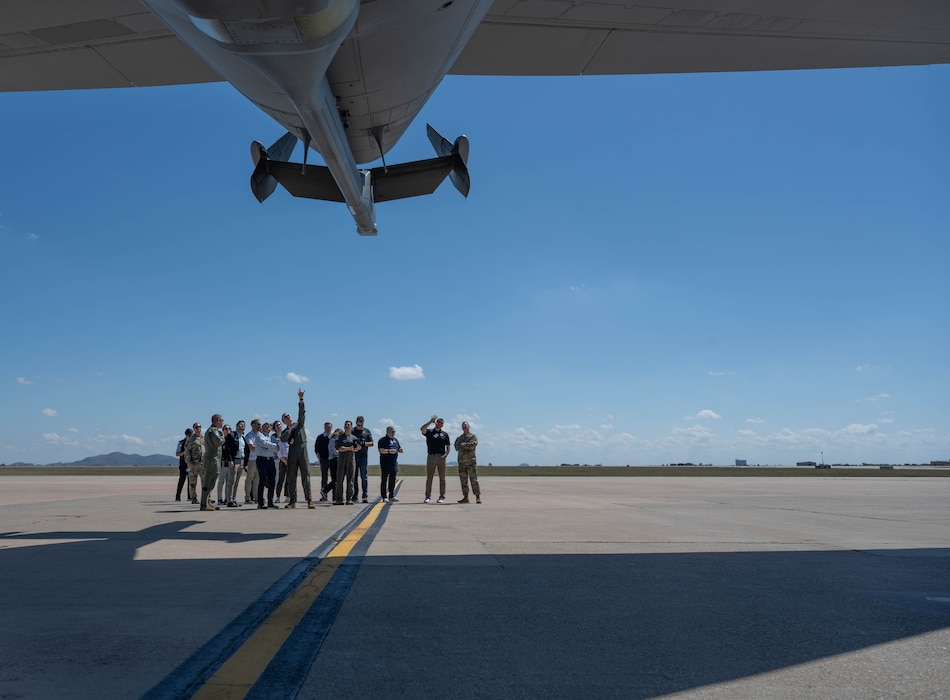 Air Mobility Command (AMC) senior leaders and civic leaders look at the back of a U.S. Air Force KC-46 Pegasus aircraft at Altus Air Force Base, Oklahoma, April 9, 2026. After viewing the static display, AMC senior leaders and civic leaders had the opportunity to tour the inside of the KC-46. (U.S. Air Force photo by Airman 1st Class Emma Wright)