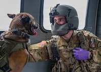 Maryland Army National Guard Staff Sgt. Colin Winand, flight paramedic non-commissioned officer for Company C, 1st Battalion, 169th Aviation Regiment, pets a Cecil County Sheriff’s K-9 during a flight onboard a UH-60 Black Hawk helicopter above Lauderick Creek Military Reservation, Edgewood, Maryland, April 1, 2026.