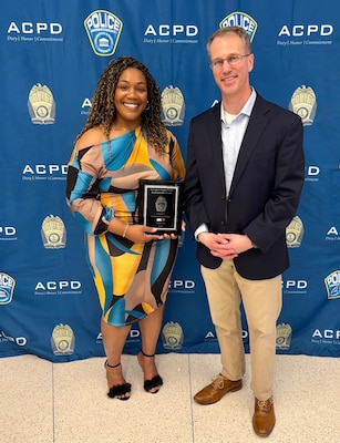 Male and female pose for photo after an award ceremony
