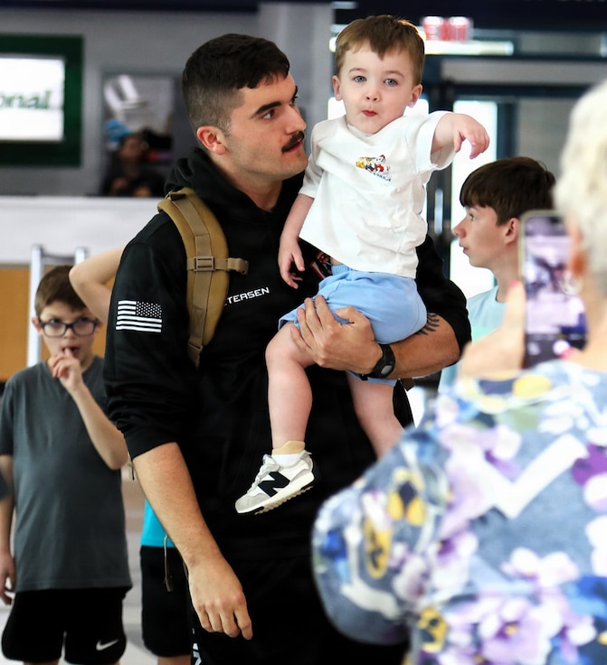 Capt. Tucker Petersen talks with his 2-year-old nephew, Wade Petersen, after Capt. Petersen's April 14 arrival at the University of Illinois Willard Airport