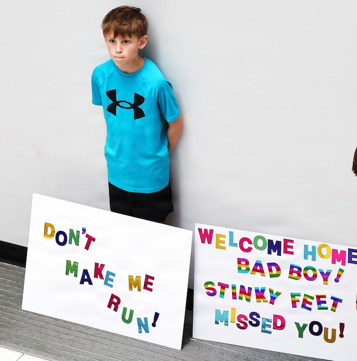Eleven-year-old Isaac, a friend of Illinois Army National Guard Capt. Tucker Petersen, waits for the captain to arrive at the University of Illinois Willard Airport