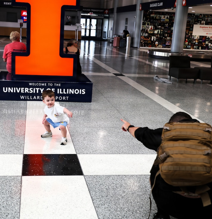 Capt. Tucker Petersen plays with his 2-year-old nephew, Wade Petersen, after Capt. Petersen's April 14 arrival at the University of Illinois Willard Airport