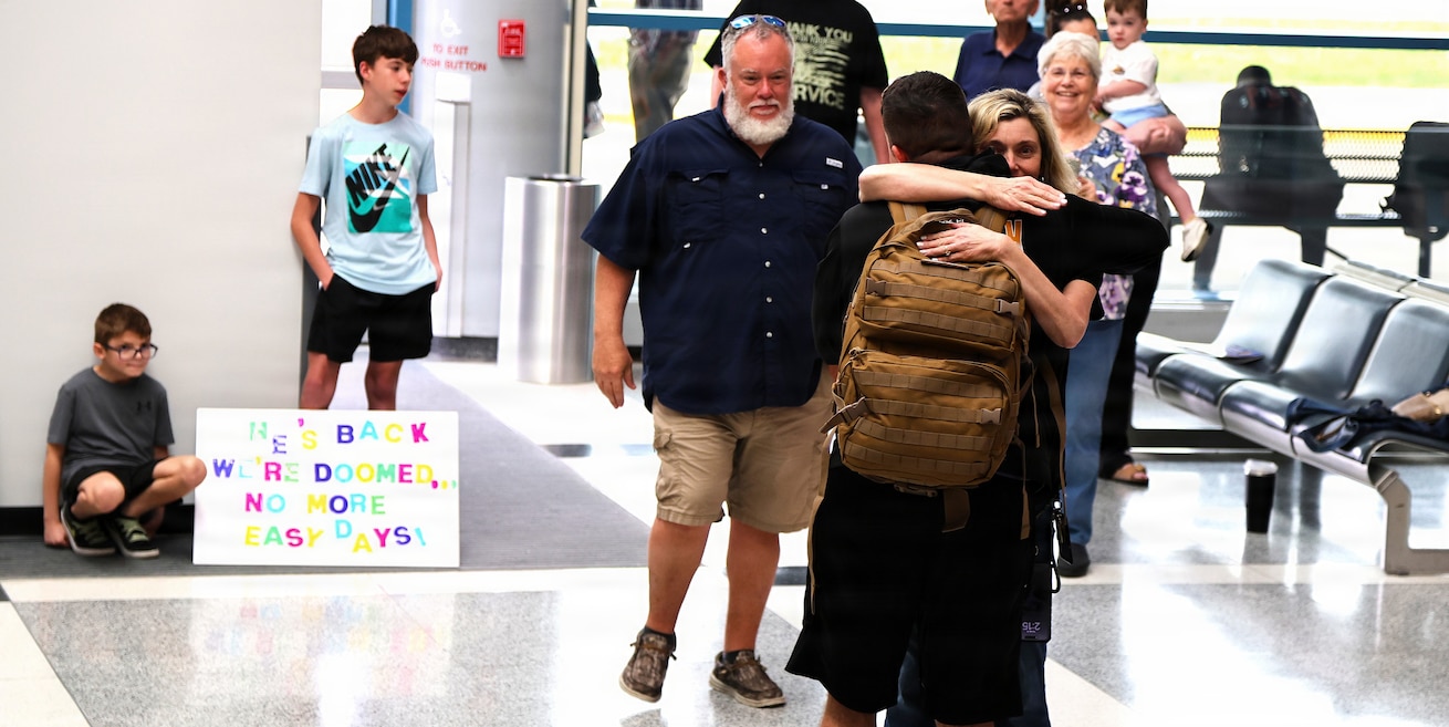 Tia Petersen hugs her son, Illinois Army National Guard Capt. Tucker Petersen, after his April 14 return from deployment.