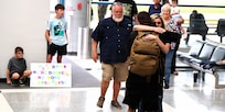 Tia Petersen hugs her son, Illinois Army National Guard Capt. Tucker Petersen, after his April 14 return from deployment.