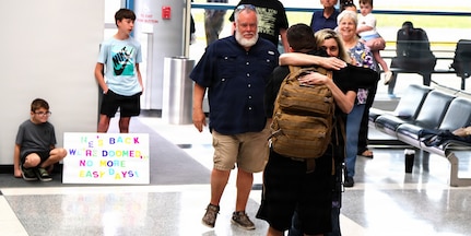 Tia Petersen hugs her son, Illinois Army National Guard Capt. Tucker Petersen, after his April 14 return from deployment.