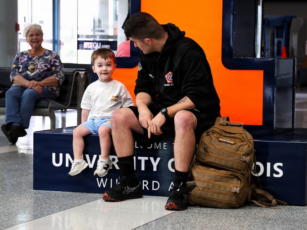 Capt. Tucker Petersen talks with his 2-year-old nephew, Wade Petersen, after Capt. Petersen's April 14 arrival at the University of Illinois Willard Airport