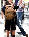Tia Petersen hugs her son, Illinois Army National Guard Capt. Tucker Petersen, after his April 14 return from deployment