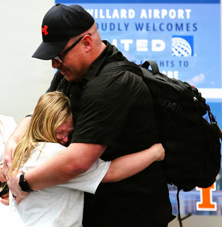 Adlynn Kirkpatrick, 10, hugs her father, Sgt. 1st Class Mathew Kirkpatrick, after his April 14 arrival at the University of Illinois Willard Airport