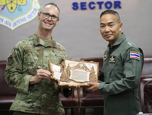 Brig. Gen. Ken Borchers, Commander, Washington Air National Guard and Assistant Adjutant General, Washington National Guard, presents gifts to Air Chief Marshal Sakesan Kantha, Commander-in-Chief, Royal Thai Air Force, during a visit to Joint Base Lewis-McChord, Wash., April 13, 2026.