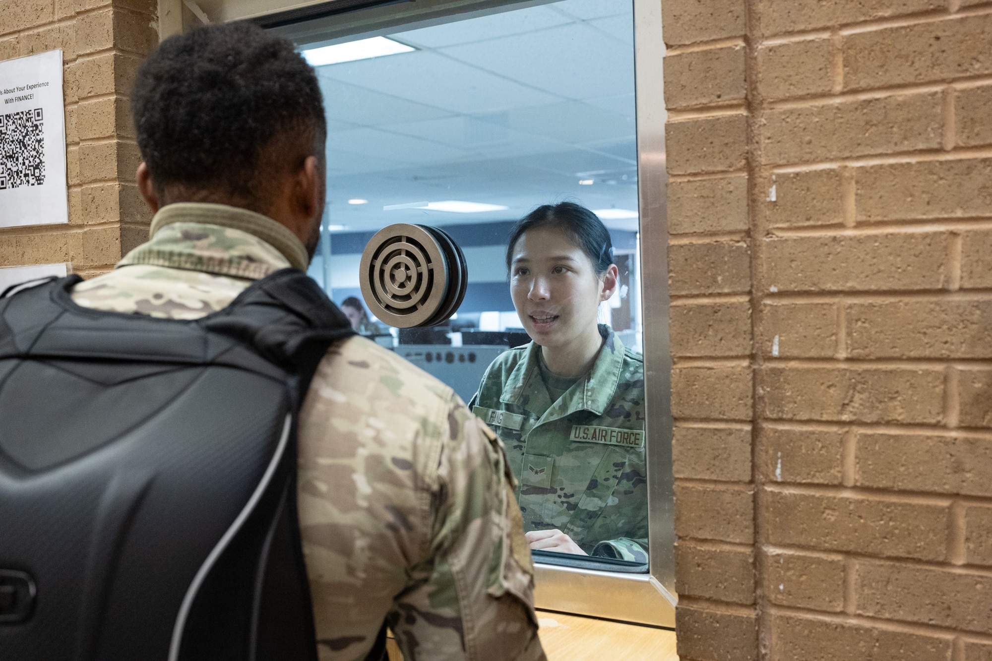 A woman stands at the help window.