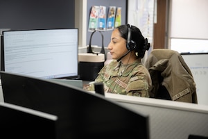 A woman sits at a desk