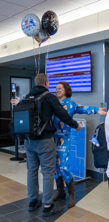 Ashley Broaddus, wife of Illinois Army National Guard Sgt. 1st Class Jason Turley, greets him during his April 14 arrival at the Abraham Lincoln Capital Airport in Springfield.