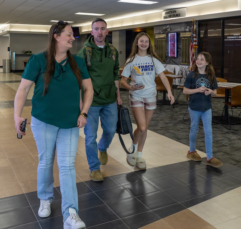 The family of Illinois Army National Guard Lt. Col. Dan Johnson, Commander, 232nd Combat Sustainment Support Battalion, wife Kristi, and daughters Kaitlyn and Bella, walk through Abraham Lincoln Capital Airport in Springfield April 14 after his arrival.