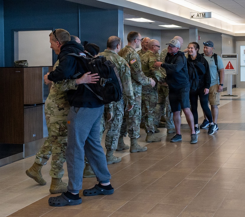 About a half dozen Soldiers from the Illinois Army National Guard's 232nd Combat Sustainment Support Battalion were greeted by senior leaders after flying into the Abraham Lincoln Capital Airport in Springfield, April 14.