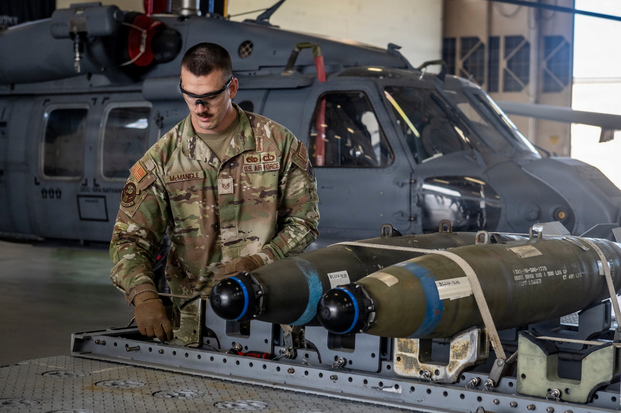 Airman preparing to move munition devices.