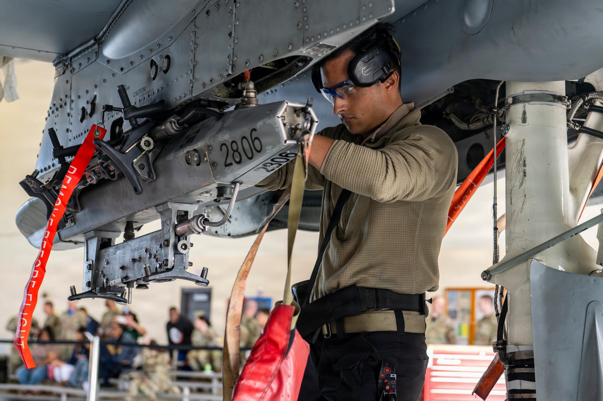 Airman loading a munitions device onto a A-10 Thunderbolt II