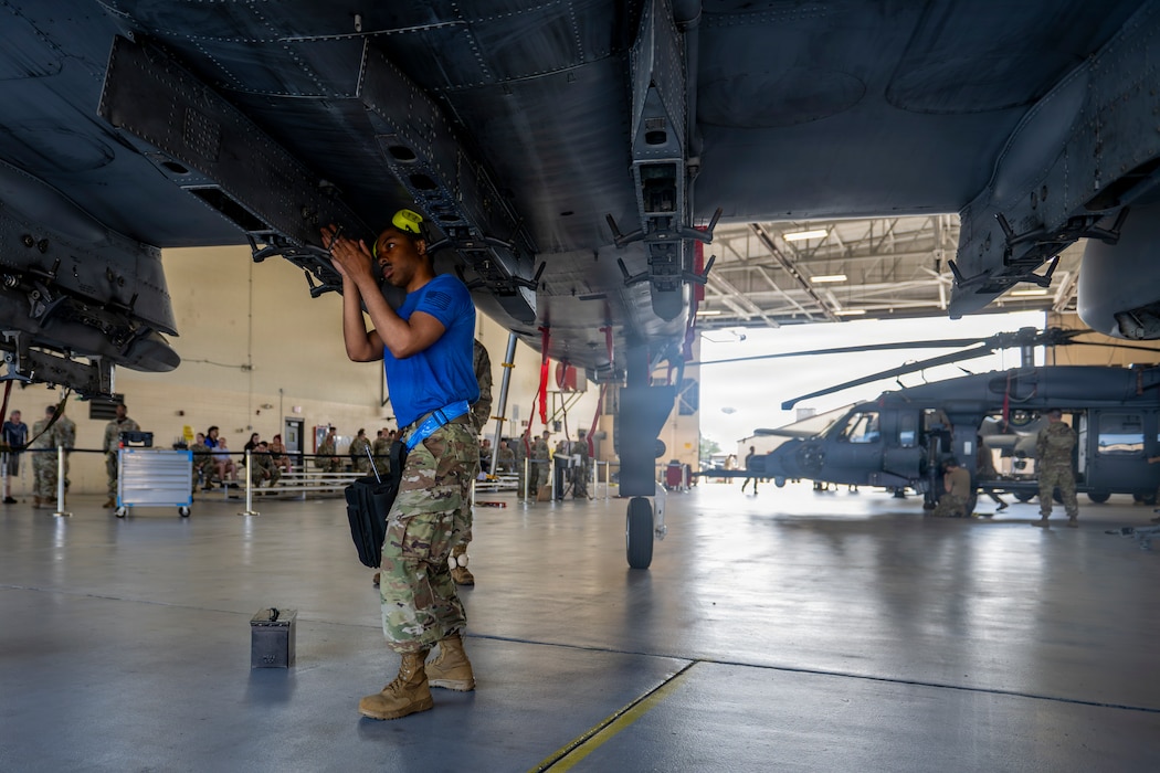 Airman preparing to install a munitions device.