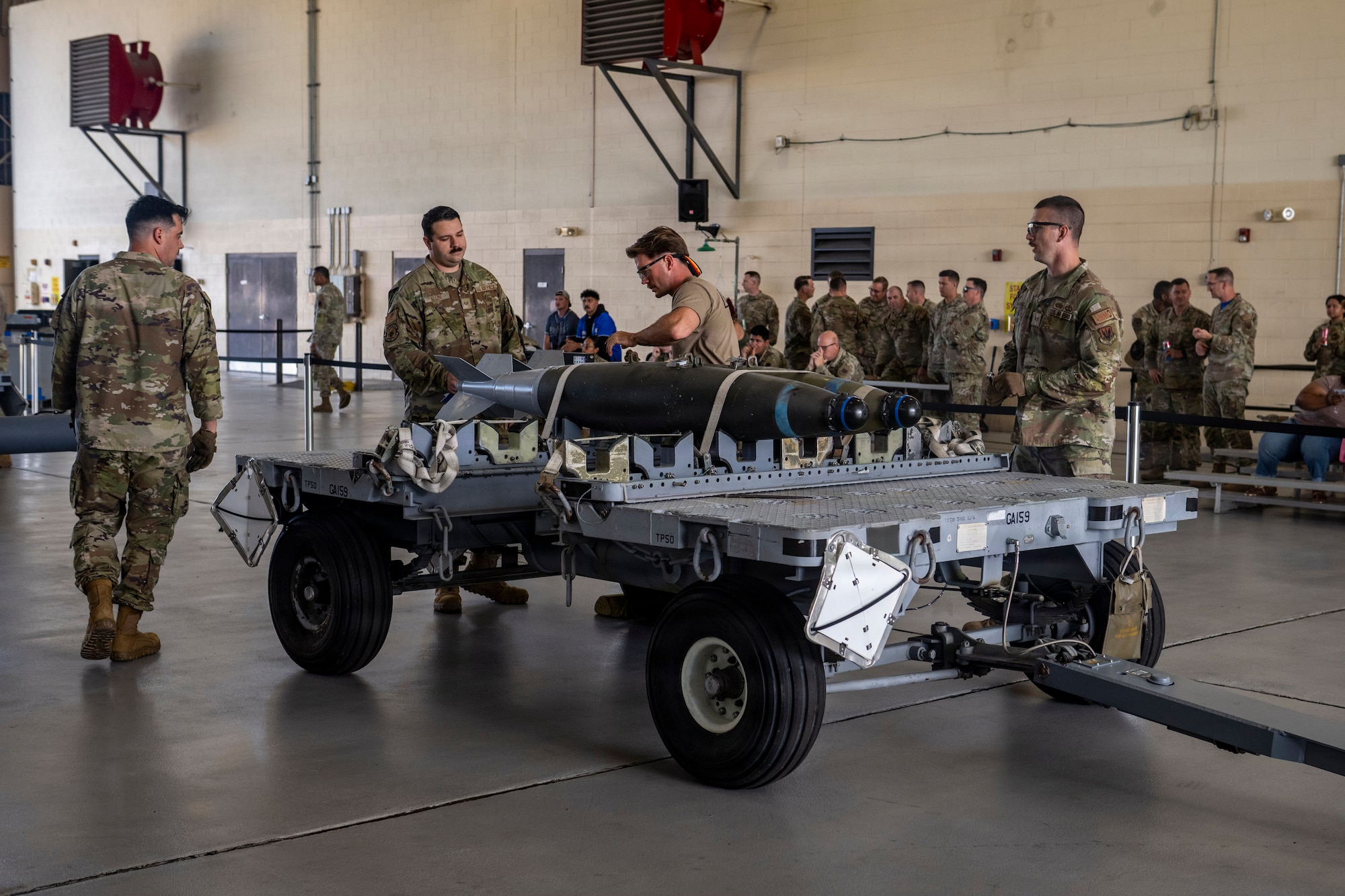 Airmen work on munitions.