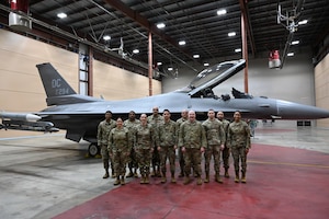 The 113th Command Post poses for a group photo in their alert control facility at Joint Base Andrews, Maryland, Mar. 23, 2026. The team was recognized as the 2025 Continental Northern American Aerospace Defense Command Region (CONR NORAD) Aerospace Control Alert (ACA) unit of the year. (U.S. Air National Guard photo by Senior Master Sgt. Craig Clapper)
