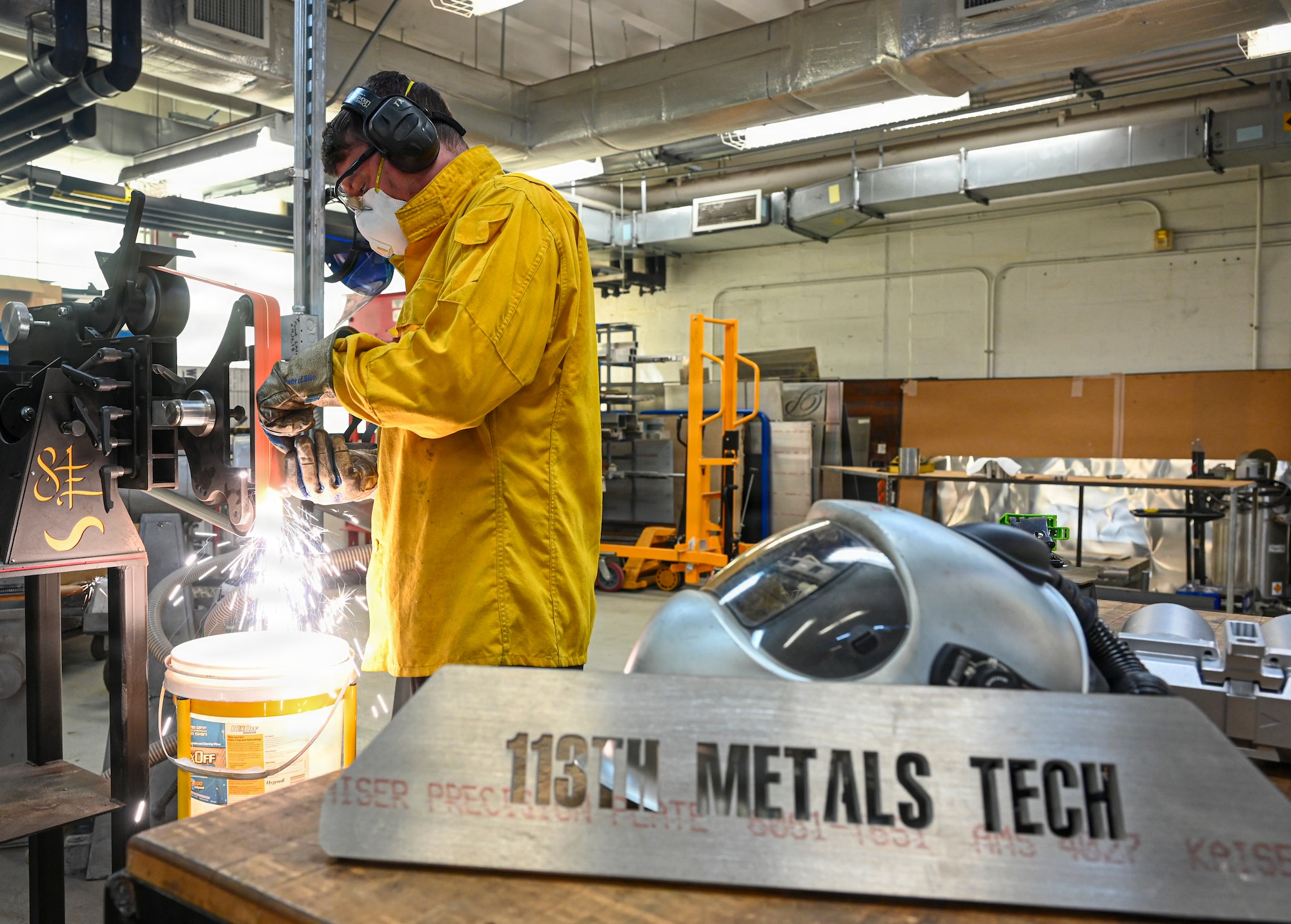 Staff Sgt. Scott Estes, aircraft metals technology technician with the 113th Maintenance Squadron, grinds a piece of sheet metal at Joint Base Andrews, Md. on Mar. 20, 2026. The metals shop is a specialized fabrication team that repairs, designs, and manufactures metal parts for aircraft and a variety of equipment on base using precise welding and Computer Numerical Control (CNC) technology. (U.S. Air National Guard Photo by Staff Sgt. Natalie Filzen)