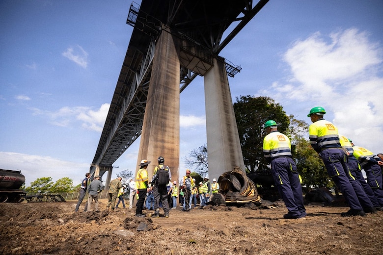 Upward viewing picture of men working on a bridge.