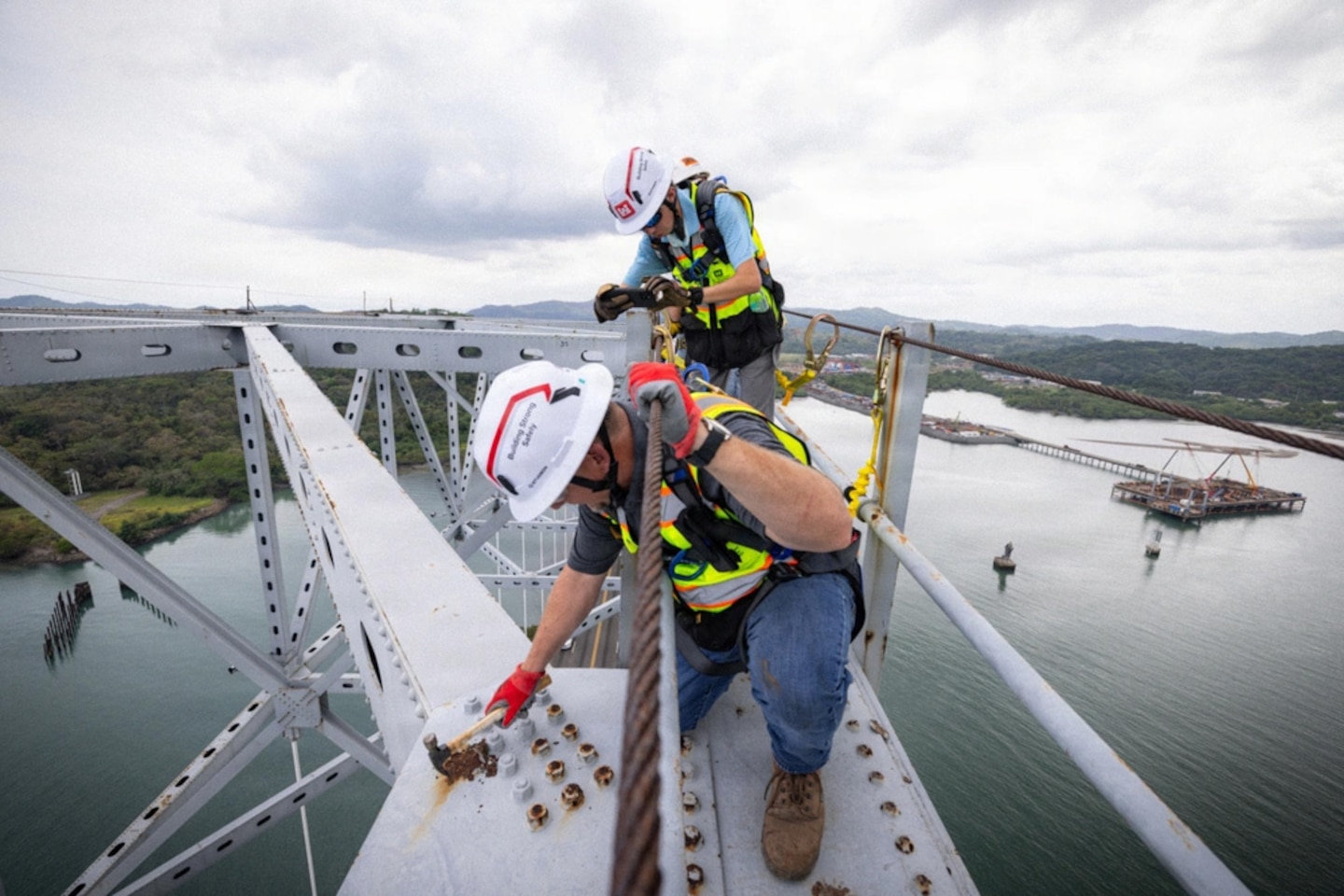 Two men working on a brodge.
