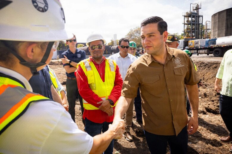 Men shaking hand at a bridge