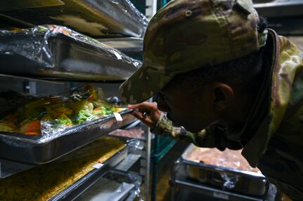 U.S. Air Force Airman 1st Class Mark Tolefree, public health technician with Bolling Medical Squadron Public Health, inspects a vegetable tray during a food handling inspection at Joint Base Anacostia-Bolling, Washington, D.C., April 1, 2026. Over the past year, BMS Public Health supported the Food Safety and Sanitation program by inspecting 37 food facilities and 17 public facilities on the JBAB installation to protect more than 18,000 military personnel, federal civilian employees and military family members against foodborne illnesses. (U.S. Air Force photo by Senior Airman Shanel Toussaint)