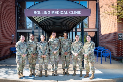 Members of the Bolling Medical Squadron’s Public Health unit gather for a photo in front of the Bolling Medical Clinic at Joint Base Anacostia-Bolling, Washington, D.C., April 8, 2026. During the past year, BMS Public Health supported the Food Safety and Sanitation program by inspecting 37 food facilities and 17 public facilities on the JBAB installation to protect more than 18,000 military personnel, federal civilian employees and military family members against foodborne illnesses. (U.S. Air Force photo by Senior Airman Shanel Toussaint)