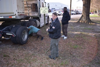 NMRLC Transportation Directorate team members, Scott Chisholm and Jason Jackson help a truck driver who encroached on an unfamiliar area.