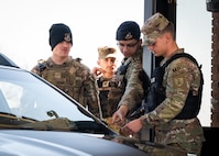 U.S. Air Force defenders demonstrate gate operations procedures to U.S. Army soldiers.