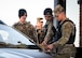 U.S. Air Force defenders demonstrate gate operations procedures to U.S. Army soldiers.