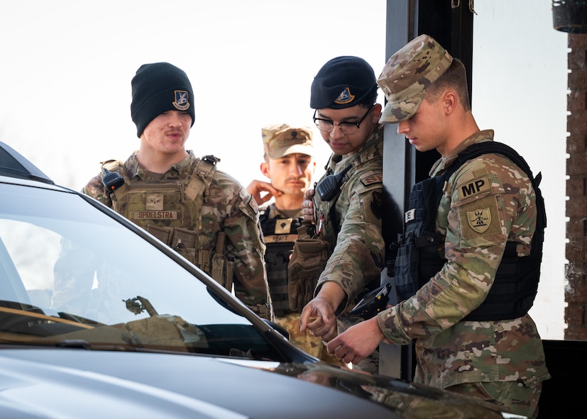 U.S. Air Force defenders demonstrate gate operations procedures to U.S. Army soldiers.
