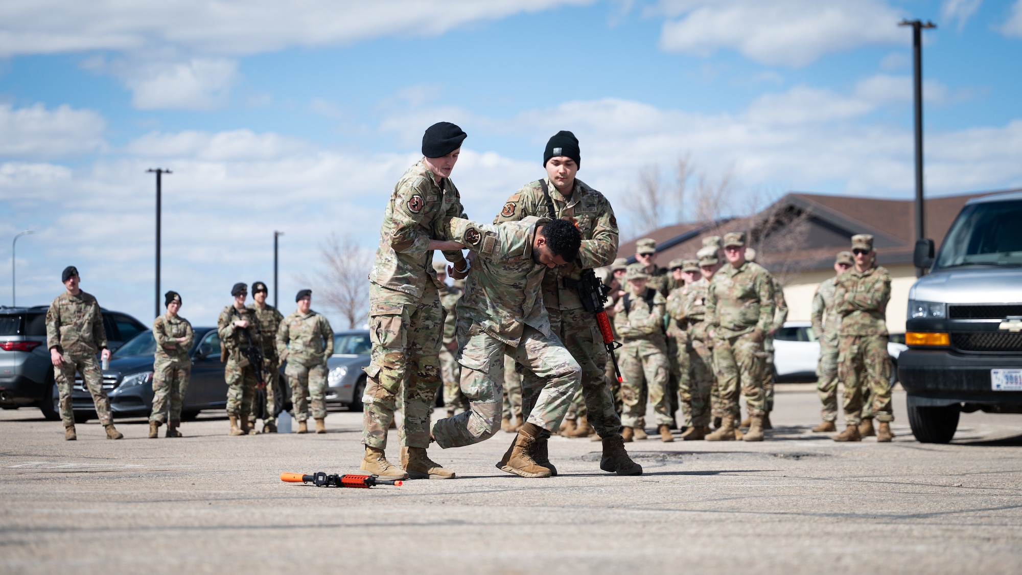 U.S. Air Force defenders demonstrate law enforcement procedures to U.S. Army soldiers.