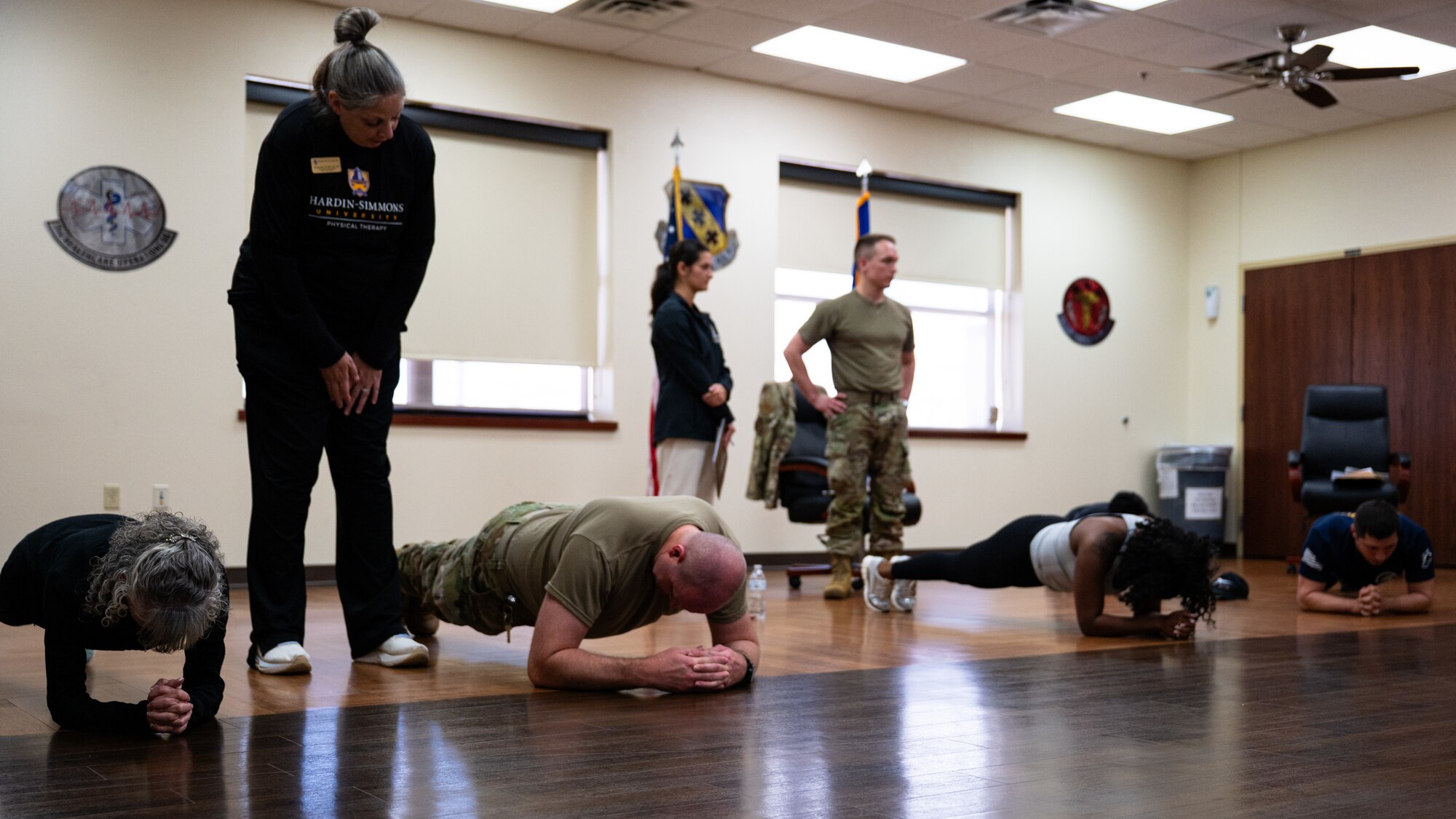 U.S. Airmen perform a plank exercise under the guidance of Hardin-Simmons University physical therapy staff at during a collaborative training event with the 7th Medical Group at Dyess Air Force Base, Texas, April 10, 2026. The instruction focused on proper techniques to improve core strength and prevent injury. (U.S. Air Force photo by Senior Airman Jade M. Caldwell)
