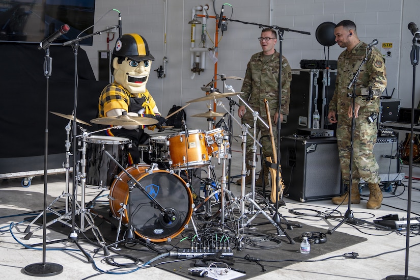 Steely McBeam, the official mascot for the Pittsburgh Steelers, plays with the Air Force Band of Mid-America at the 171st Air Refueling Wing during an All-Star Leadership Day in Pittsburgh, Pennsylvania, April 15, 2026. Airmen shared their experiences and perspectives, encouraging students to consider leadership roles and STEM-focused careers within the U.S. Air Force. (U.S. Air National Guard photo by Tech. Sgt. Zoe M. Wockenfuss)