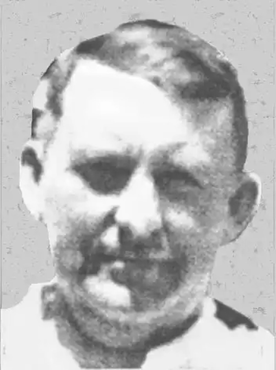 A close-up of a man’s face as he poses for a photo.