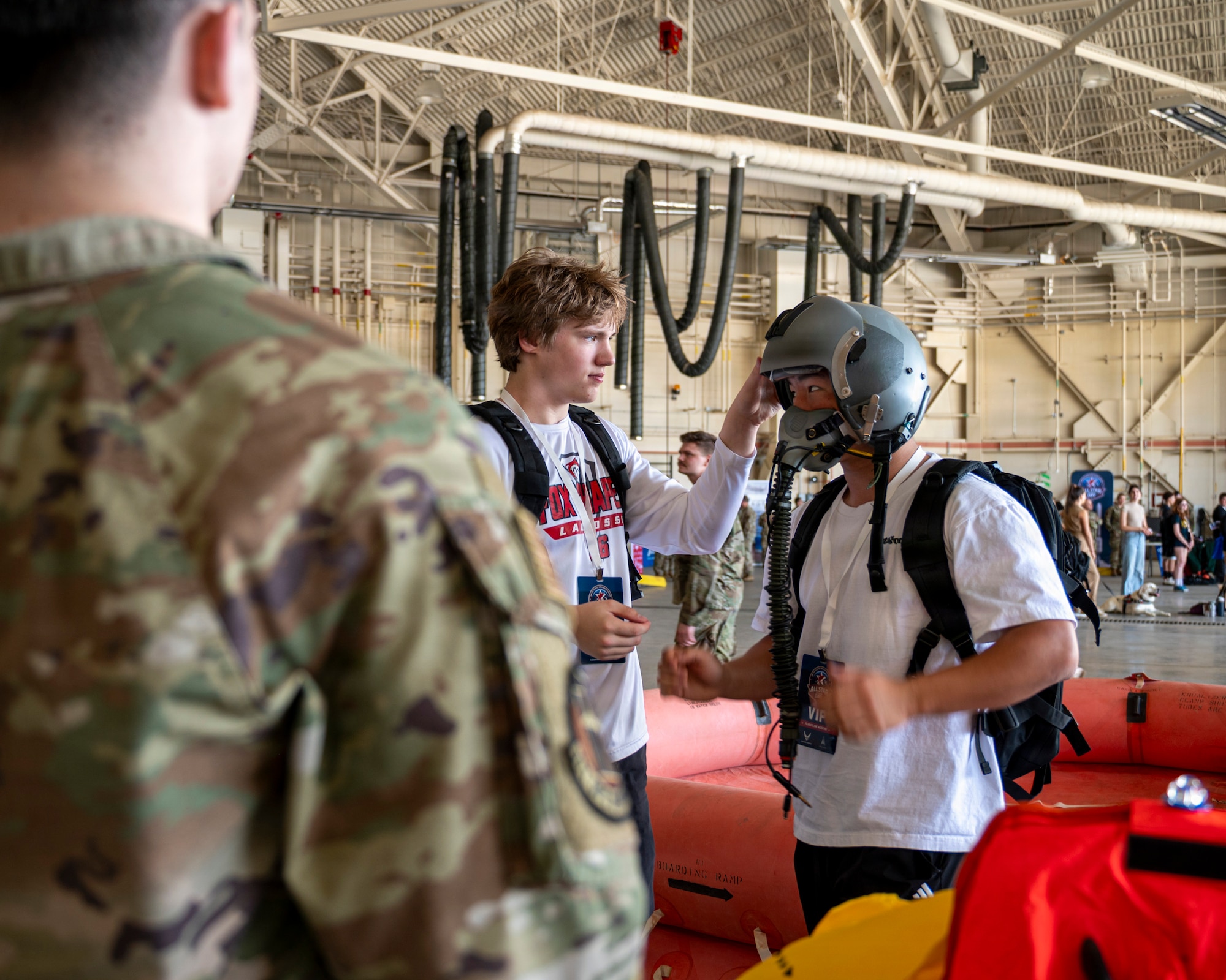 A student tries on an aircrew helmet at the 171st Air Refueling Wing during an All-Star Leadership Day in Pittsburgh, Pennsylvania, April 15, 2026. Airmen shared their experiences and perspectives, encouraging students to consider leadership roles and STEM-focused careers within the U.S. Air Force. (U.S. Air National Guard photo by Tech. Sgt. Zoe M. Wockenfuss)