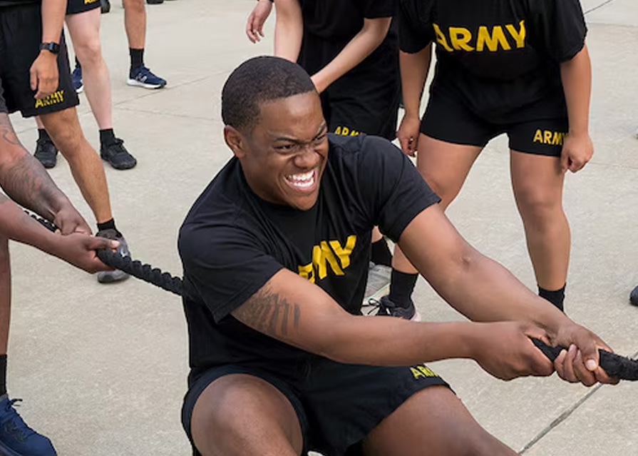 A service member playing tug of war