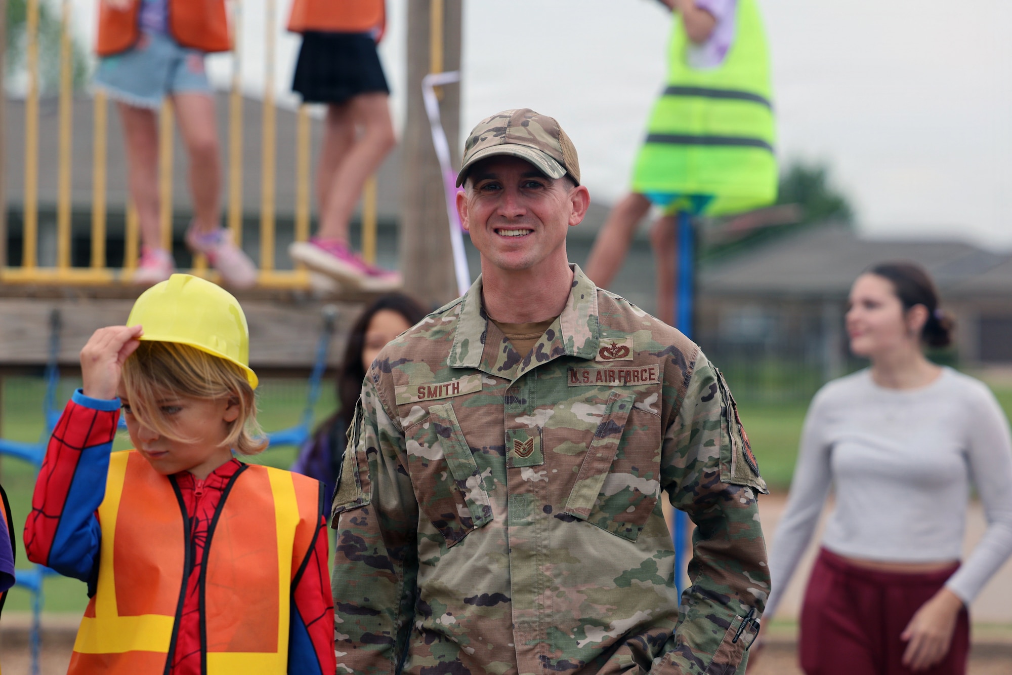 TSgt Smith poses for a photo with newly upgraded playground equipment at Sheppard Elementary