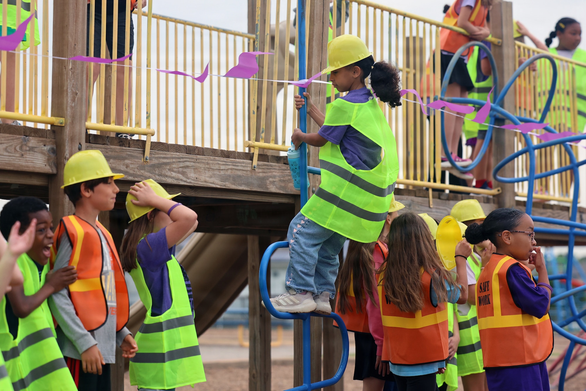 A student from Sheppard Elementary tests out upgraded playground equipment