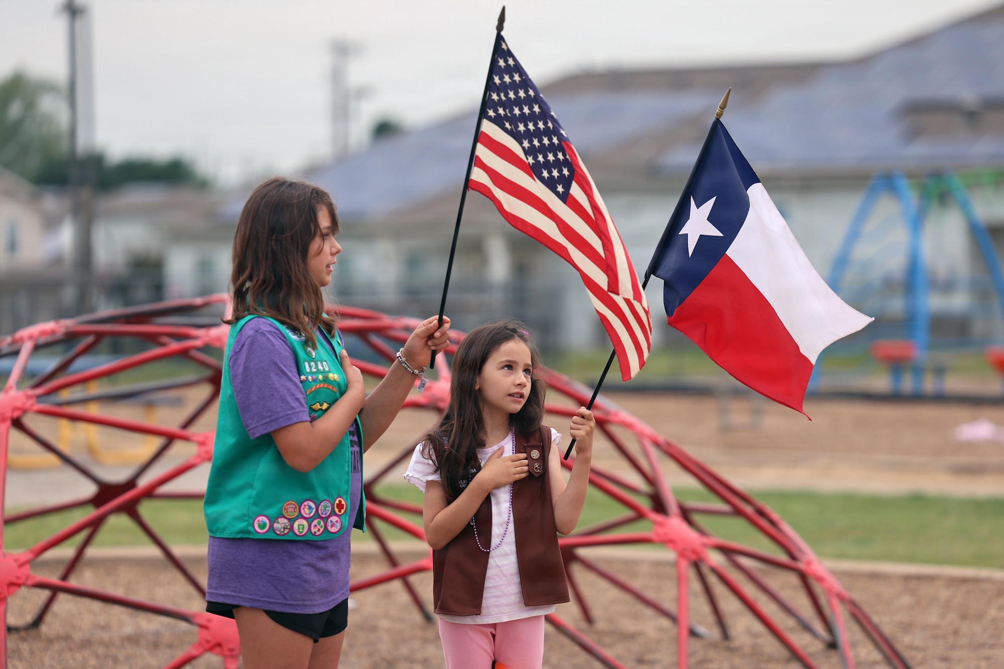 Students from Sheppard Elementary recite the pledge of allegiance at a ribbon cutting to newly upgraded playground equipment
