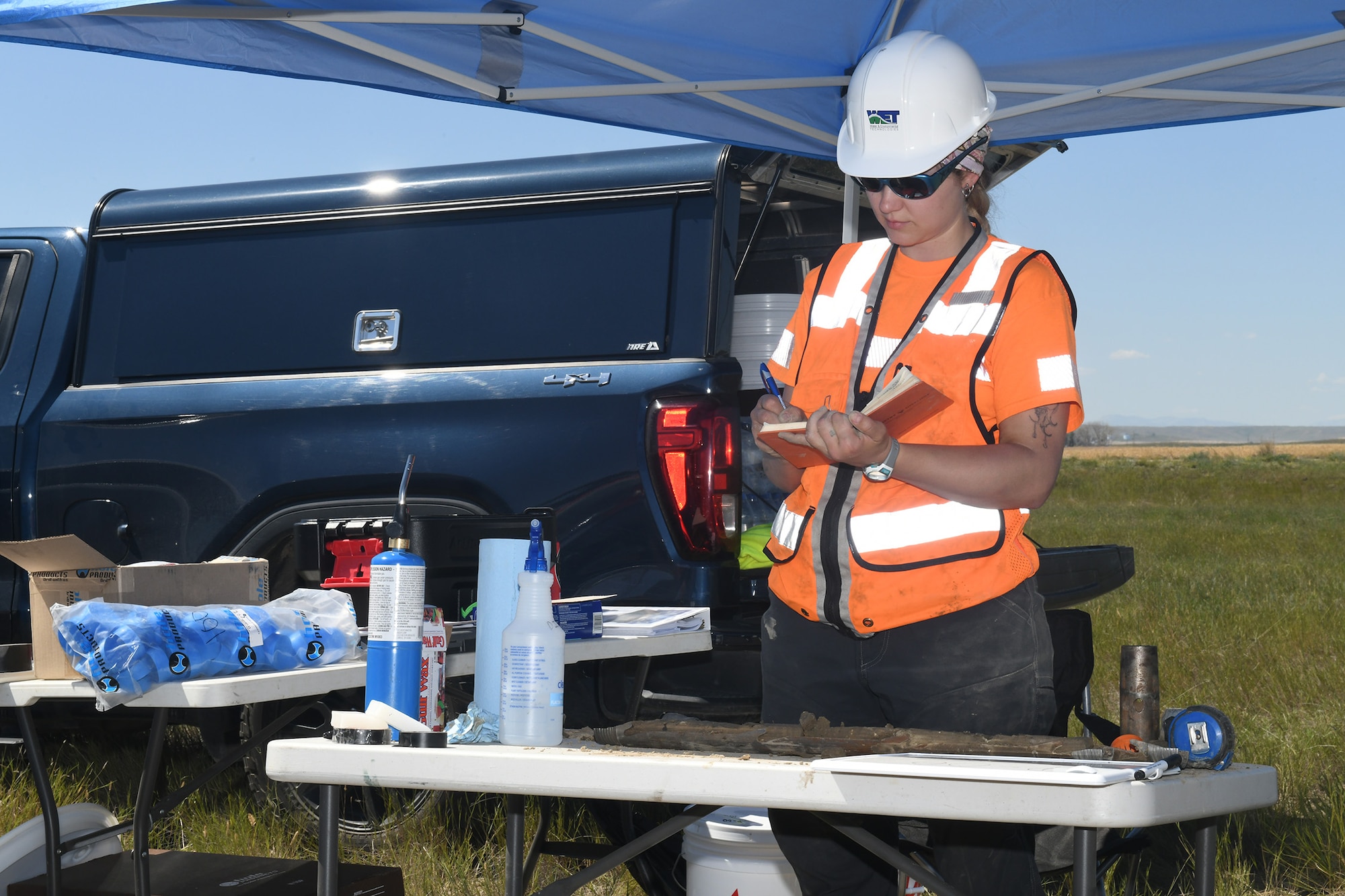 A scientist logs a soil sample's lithology.