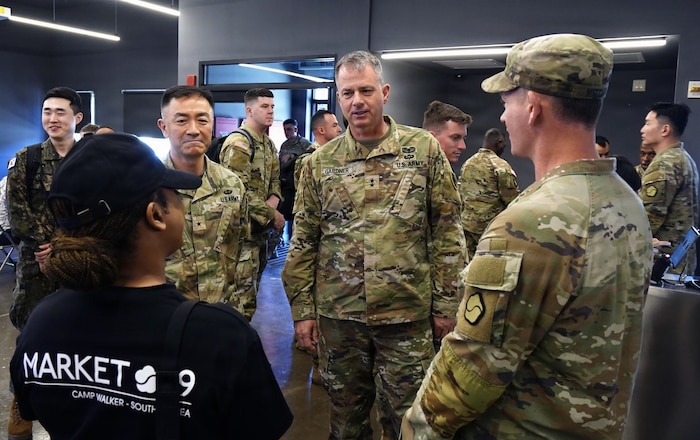 U.S. Army Maj. Gen. Gavin Gardner, commanding general of the 8th Theater Sustainment Command, and Brig. Gen. Jin Pak, commanding general of the 19th Expeditionary Sustainment Command, speak with Soldiers and staff inside the Market 19 autonomous kitchen at Camp Walker, Daegu, Republic of Korea, April 7, 2026.
