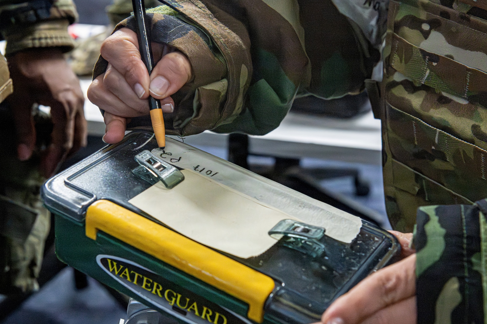 U.S. Air Force Maj. Claudia Teruel, 35th Surgical Operations Squadron element chief, labels M8 chemical agent detector paper during a chemical, biological, radiological and nuclear (CBRN) class.