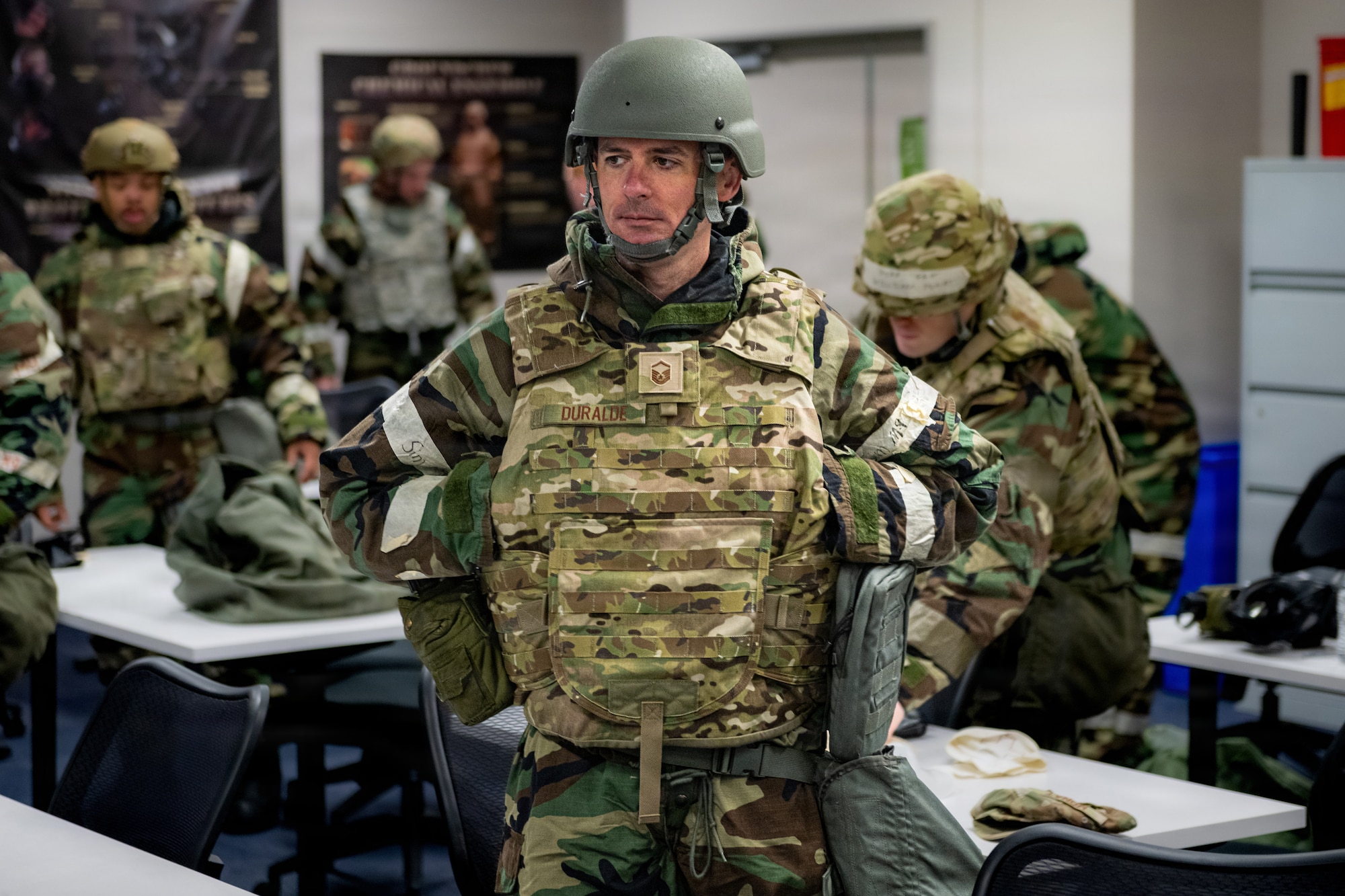 U.S. Air Force Master Sgt. Rafael Duralde, 35th Maintenance Squadron chief of complaints resolution, dons mission oriented protective posture gear during a chemical, biological, radiological and nuclear (CBRN) class.