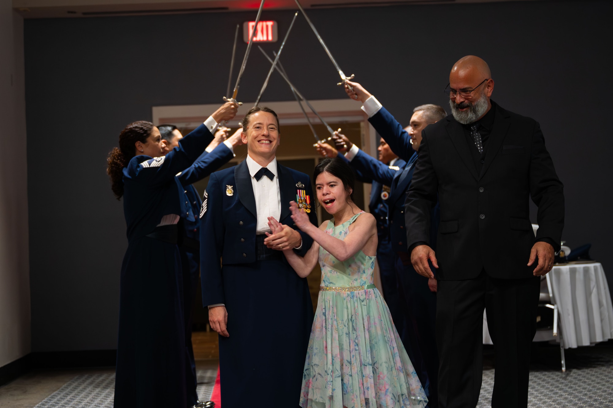U.S. Air Force Chief Master Sgt. Select Heather Clifton, 312th Training Squadron Superintendent, walks the cordon of honor with her family at the Chief Recognition Ceremony.