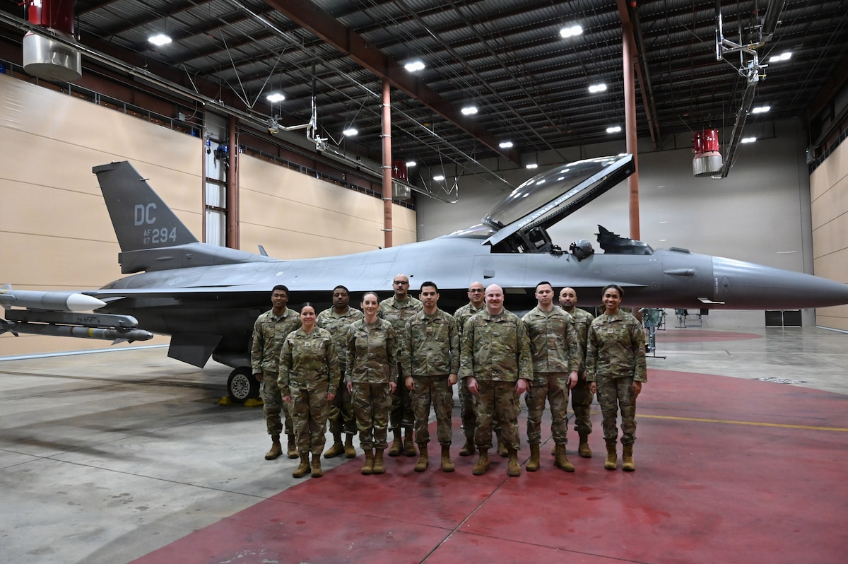 The 113th Command Post poses for a group photo in their alert control facility at Joint Base Andrews, Maryland, Mar. 23, 2026. The team was recognized as the 2025 Continental Northern American Aerospace Defense Command Region (CONR NORAD) Aerospace Control Alert (ACA) unit of the year. (U.S. Air National Guard photo by Senior Master Sgt. Craig Clapper)