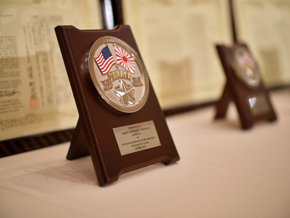 YOKOSUKA, Japan (April 10, 2026) -- A plaque for Fleet Activities Yokosuka rests on the awards table at the U.S. & Japan Navy Friendship Association (JANAFA) Awards Ceremony April 10, 2026 at Hotel Mercure in Yokosuka, Japan. JANAFA, built on a strong bond of trust and friendship between the U.S. Navy and Japan Maritime Self-Defense Force (JMSDF), presented Commander, Fleet Activities Yokosuka (CFAY) a Letter of Appreciation on behalf of the command. (U.S. Navy photo by James Kimber)